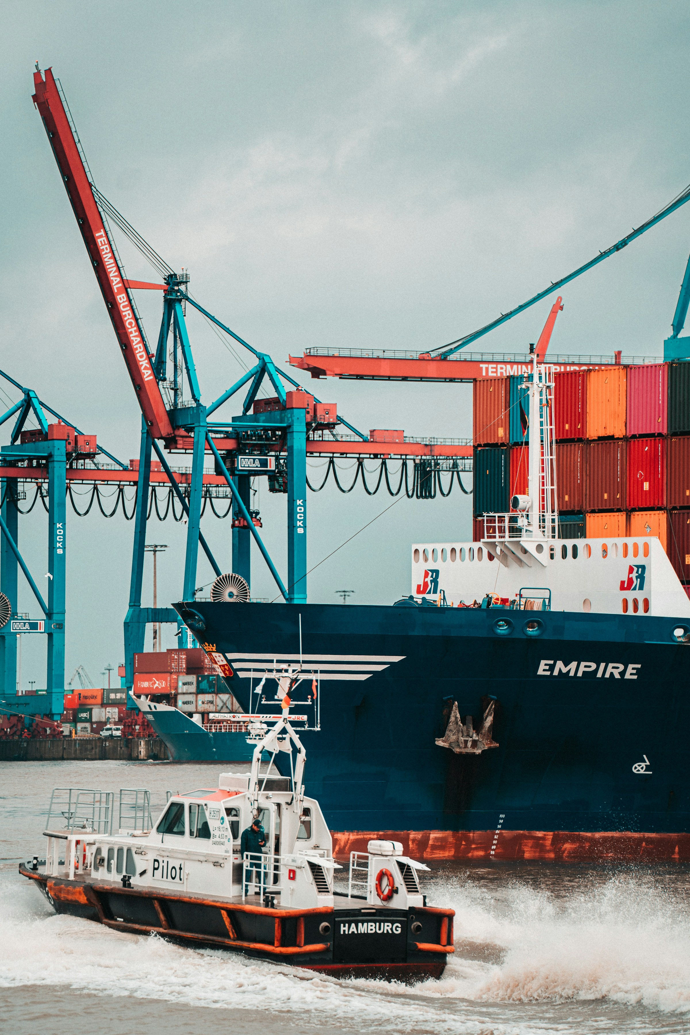 Container ship and pilot boat at an international port — symbolising global reach